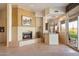 Living area with a fireplace, wet bar, and sliding glass doors leading to the outdoors at 7848 E Parkview Ln, Scottsdale, AZ 85255