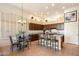 Bright kitchen featuring dark wood cabinets, granite countertops, and seating at a breakfast bar at 7848 E Parkview Ln, Scottsdale, AZ 85255