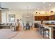 Open-concept living and dining area with tile floors, island seating, and a neutral color palette at 7848 E Parkview Ln, Scottsdale, AZ 85255