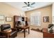 Office features wood desk, leather chair, bookshelves, and a ceiling fan at 7848 E Parkview Ln, Scottsdale, AZ 85255