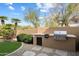 Outdoor kitchen area with built-in grill, perfect for entertaining guests at 7848 E Parkview Ln, Scottsdale, AZ 85255