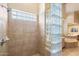 Tiled shower stall with glass block wall allows natural light into bathroom at 7848 E Parkview Ln, Scottsdale, AZ 85255