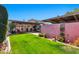 Private backyard featuring a covered patio, well-manicured lawn, and privacy fencing for outdoor enjoyment at 8230 E Valley Vista Dr, Scottsdale, AZ 85250