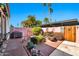 This backyard has mature desert landscaping with a brick patio and a pink stucco wall at 8230 E Valley Vista Dr, Scottsdale, AZ 85250