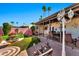 Inviting backyard with manicured landscaping, an outdoor dining area, and palm trees at 8230 E Valley Vista Dr, Scottsdale, AZ 85250