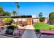 Spacious backyard with manicured landscaping, a paved walkway, and comfortable seating at 8230 E Valley Vista Dr, Scottsdale, AZ 85250