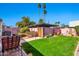 Secluded backyard featuring lush greenery, lounge chairs, and tall palm trees at 8230 E Valley Vista Dr, Scottsdale, AZ 85250