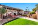 Secluded backyard featuring a lush lawn, stone patio, and mature landscaping at 8230 E Valley Vista Dr, Scottsdale, AZ 85250