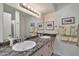 Bathroom with double sink vanity, large mirror with decorative lighting, and stylish decor at 8230 E Valley Vista Dr, Scottsdale, AZ 85250