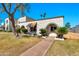 Inviting single-story home featuring a well-kept lawn, arched entryway, and desert landscaping at 8230 E Valley Vista Dr, Scottsdale, AZ 85250