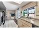 Bright kitchen featuring a garden window above a double basin sink and tile flooring at 8230 E Valley Vista Dr, Scottsdale, AZ 85250