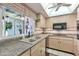 Well-lit kitchen featuring neutral countertops, natural light, and efficient appliances at 8230 E Valley Vista Dr, Scottsdale, AZ 85250