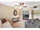 Cozy living room with comfortable seating, a ceiling fan, and built-in shelving at 8230 E Valley Vista Dr, Scottsdale, AZ 85250