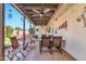 Relaxing covered patio with ceiling fans, comfortable seating, and outdoor dining area at 8230 E Valley Vista Dr, Scottsdale, AZ 85250