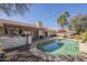 Refreshing backyard pool with a patio, lush landscaping, and an outdoor kitchen at 8984 E Sutton Dr, Scottsdale, AZ 85260