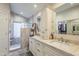 Elegant bathroom features dual vanities, modern fixtures, and a walk-in shower with glass block accents at 8984 E Sutton Dr, Scottsdale, AZ 85260