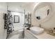 Well-lit bathroom with a vessel sink, a large mirror, and a shower-tub combo at 8984 E Sutton Dr, Scottsdale, AZ 85260