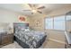 Comfortable bedroom with neutral walls, a ceiling fan, and natural light at 8984 E Sutton Dr, Scottsdale, AZ 85260