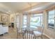 Bright dining area featuring a modern chandelier and views of the refreshing backyard pool at 8984 E Sutton Dr, Scottsdale, AZ 85260