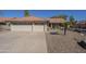 Charming single-story home with a tile roof, two-car garage, and low-maintenance desert landscaping at 8984 E Sutton Dr, Scottsdale, AZ 85260