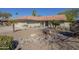 Inviting single-story home featuring desert landscaping, a tile roof, and a welcoming front entrance at 8984 E Sutton Dr, Scottsdale, AZ 85260