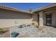 Cozy front porch area with seating, potted plants, and decorative stone flooring at 8984 E Sutton Dr, Scottsdale, AZ 85260