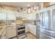 Stylish kitchen featuring stainless steel appliances, updated cabinetry and mosaic backsplash at 8984 E Sutton Dr, Scottsdale, AZ 85260