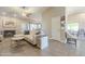 Spacious living room with a fireplace, tile flooring, and an open layout to the dining area at 8984 E Sutton Dr, Scottsdale, AZ 85260