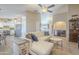 Open-concept living room with tile flooring, a ceiling fan, and stylish decor at 8984 E Sutton Dr, Scottsdale, AZ 85260