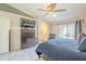 Relaxing main bedroom with a ceiling fan, backyard views, and sleek dresser for ample storage space at 8984 E Sutton Dr, Scottsdale, AZ 85260