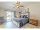 Sunlit main bedroom featuring a luxurious bed, stylish furniture, and sliding door access to the outdoor pool at 8984 E Sutton Dr, Scottsdale, AZ 85260