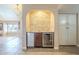 Entertainment area featuring wine storage, refrigeration, and granite countertops at 8984 E Sutton Dr, Scottsdale, AZ 85260