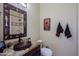 Bathroom featuring a granite countertop, decorative mirror, and unique copper sink at 9576 E Kiisa Dr, Scottsdale, AZ 85262