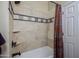 Bathroom with a tile shower and a white bathtub and shower curtain at 9576 E Kiisa Dr, Scottsdale, AZ 85262