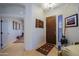 Bright foyer with hardwood floors, decorative art, and a dark wood front door at 9576 E Kiisa Dr, Scottsdale, AZ 85262