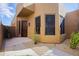 Beautiful stucco home with a dark wood door, desert landscaping and gravel at 9576 E Kiisa Dr, Scottsdale, AZ 85262