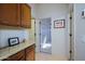 Hallway with beautiful wood flooring, white walls, and an entrance to a bedroom at 9576 E Kiisa Dr, Scottsdale, AZ 85262