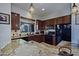 Kitchen with granite counters, black appliances, and wood cabinetry at 9576 E Kiisa Dr, Scottsdale, AZ 85262