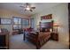 Cozy main bedroom with stylish furniture, wood accents, and a relaxing ambiance at 9576 E Kiisa Dr, Scottsdale, AZ 85262