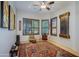 Bright sitting room with hardwood floors, a decorative rug, and plantation shutters at 9576 E Kiisa Dr, Scottsdale, AZ 85262