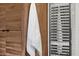 Contemporary bathroom with a heated towel rack next to modern wood cabinets and a white towel at 10006 N 79Th Pl, Scottsdale, AZ 85258