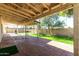 Expansive covered brick patio area leading to a well-maintained backyard and lush lawn at 10008 N 50Th Dr, Glendale, AZ 85302