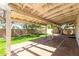 Spacious brick patio with a covered pergola overlooking the lush, green backyard at 10008 N 50Th Dr, Glendale, AZ 85302