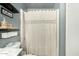 Well-appointed bathroom featuring decorative shelving and a textured shower curtain at 10008 N 50Th Dr, Glendale, AZ 85302
