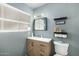 Modern bathroom with stylish vanity, sleek fixtures and contemporary decorative shelving at 10008 N 50Th Dr, Glendale, AZ 85302