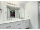 Bathroom featuring double sinks, white cabinetry, granite countertops, and a bright, clean aesthetic at 10008 N 50Th Dr, Glendale, AZ 85302
