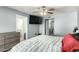 Bedroom featuring a large window, closet, dresser, and a comfortable bed with patterned bedding at 10008 N 50Th Dr, Glendale, AZ 85302