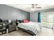Comfortable bedroom with ceiling fan, sliding glass door to the backyard, and modern furnishings at 10008 N 50Th Dr, Glendale, AZ 85302