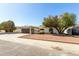 A single-story home featuring a two-car garage, desert landscaping and mature trees at 10008 N 50Th Dr, Glendale, AZ 85302