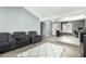 Open-concept living room with sectional sofa, neutral decor, and tile flooring at 10008 N 50Th Dr, Glendale, AZ 85302